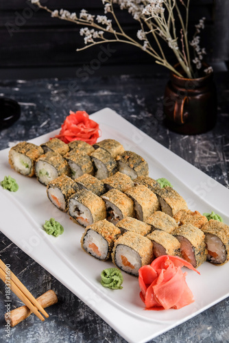 Modern fusion tempura sushi served with condiments and sauce