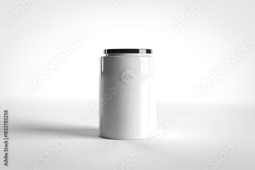 Minimalist white cylinder with black cap on white background