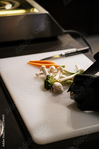 Experienced Cook Methodically Chops Vegetables in Cozy Kitchen Setting