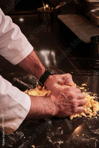 Professional cook working swiftly with flour and crumbs everywhere