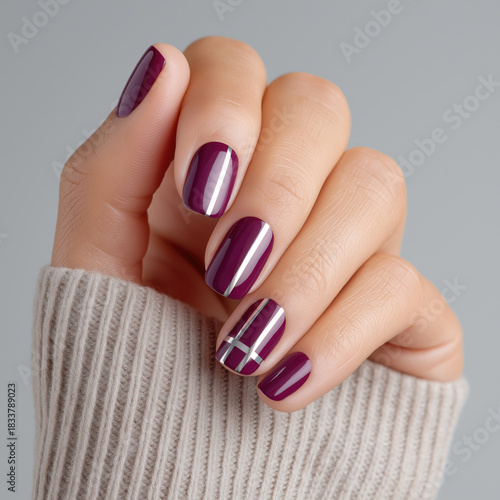 Elegant burgundy manicure with silver stripes