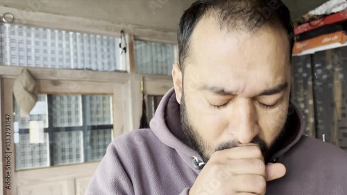 Hands, man and sick with chest pain for cough, asthma and infection virus in living room. Home, male person and respiratory illness on couch for pneumonia, tuberculosis and bacteria with flu