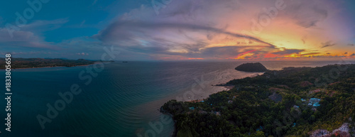 Panoramic sunset aerial of Sakatia Island, Nosy Be, Madagascar – golden light over the ocean, tropical coastline, and peaceful island landscape.