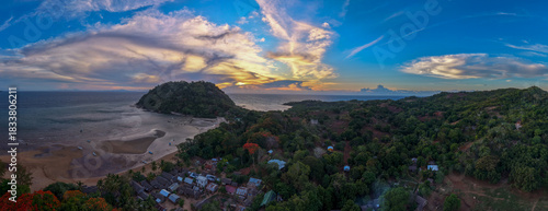 Panoramic sunset aerial of Sakatia Island, Nosy Be, Madagascar – golden light over the ocean, tropical coastline, and peaceful island landscape.