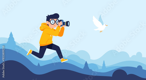 A young, enthusiastic photographer in a vibrant yellow hoodie runs through a serene blue landscape, capturing a graceful white bird in flight with his camera.