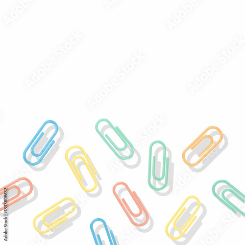 Colorful pastel paper clips scattered randomly on a clean white background, creating a playful and organized office supplies pattern.