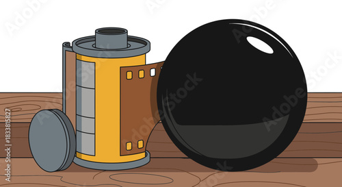 A charming illustration presents a classic 35mm film canister with exposed film, positioned beside a shiny black sphere, all resting on a warm, textured wooden surface.