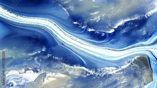 Macro video of flowing blue and white paint river texture