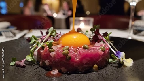 Gourmet Tuna Tartare Dish With Fresh Microgreens And Rich Egg Yolk Drizzle In Elegant Fine Dining Restaurant Setting