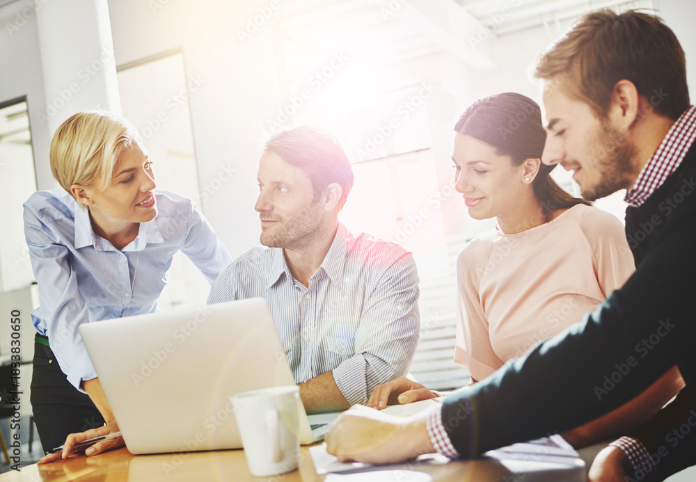 Obraz premium Conversation, finance and laptop with business people at desk in office for accounting or budget. Collaboration, computer and flare with accountant group in financial workplace for research or review