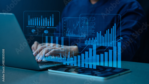 Executive monitoring corporate growth projection and financial market performance using innovative AI-powered analysis platform with dynamic virtual data dashboard on laptop.