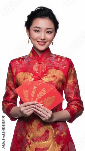 A woman in traditional red attire joyfully holds festive envelopes, symbolizing prosperity and celebration.