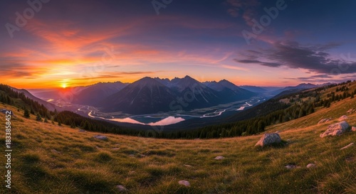 Majestic mountain valley at sunset with vibrant sky