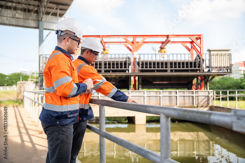 engineers are inspecting the wastewater treatment plant and checking the water in the treatment plant