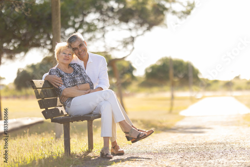 Happy senior couple embracing, enjoying leisure in park
