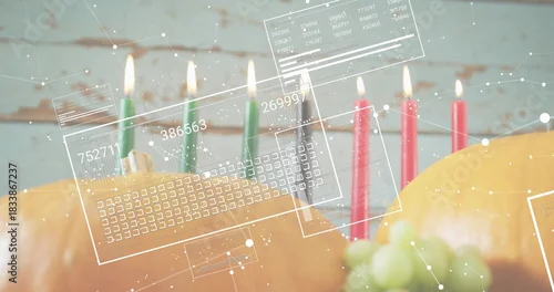 Fototapeta samoprzylepna Showing two pumpkins sitting on wood table with lit candles, grapes, aqua backdrop, HUD overlays