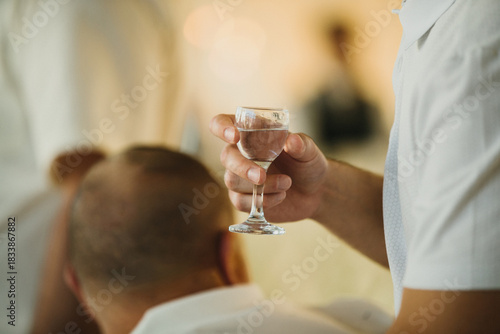Man holding small glass for a celebration toast
