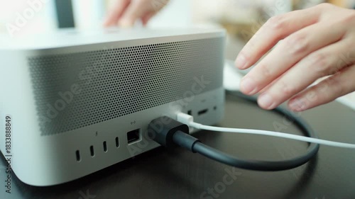 Connecting USB Cable to Desktop Computer in Modern Workspace