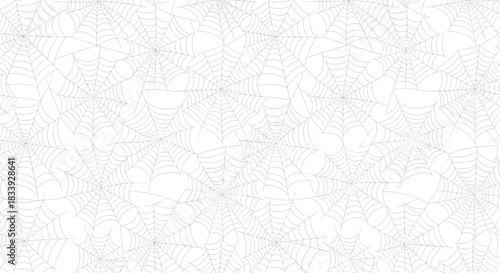 Seamless monochrome background pattern of intricately overlapping spiderwebs, perfect for Halloween-themed designs and textures.