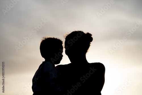 Mother carrying son pointing direction in nature