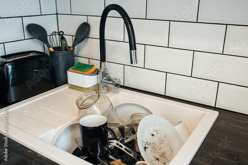 a full sink of dirty dishes before cleaning