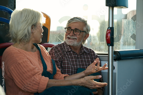 Senior couple enjoying conversation on public bus
