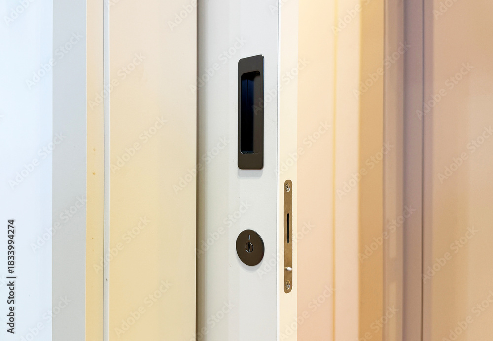 Naklejka premium Sliding door concealed handle and key lock modern minimal style.