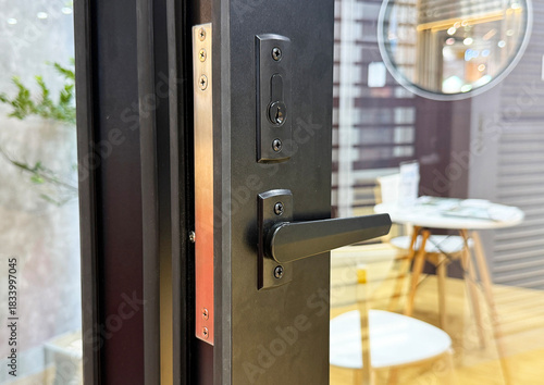 Black aluminium door handle background.