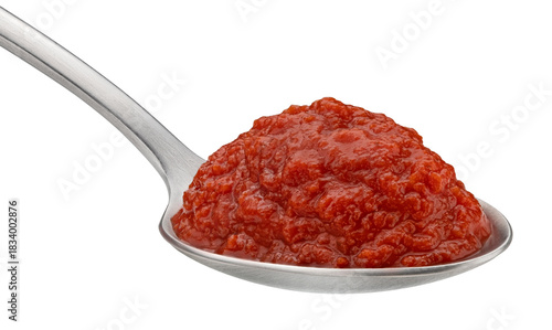Tomato paste in spoon isolated on white background