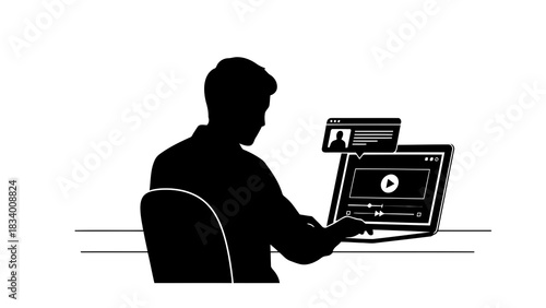 Silhouette of a person watching a video on a laptop
