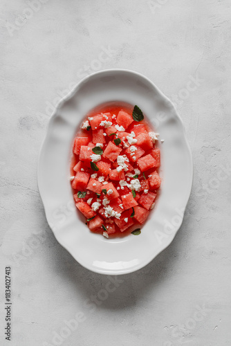  Salad made with watermelon, feta, and mint leaves.