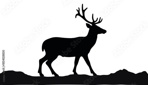 Silhouette of a deer walking over a textured landscape at dusk  