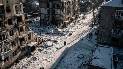 Aerial view of a war-torn snowy city with destroyed buildings and debris after a devastating conflict