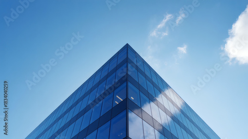 Modern Glass Office Building Against Clear Blue Sky