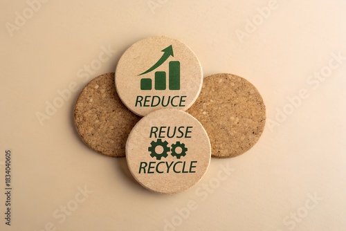 Reduce reuse recycle concept with round cork coasters on a beige background flat lay