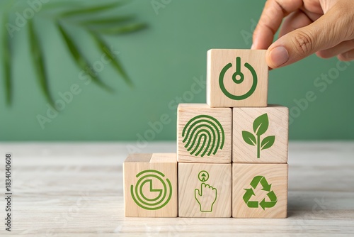 Hand placing wooden block with power icon on stack for eco friendly concept