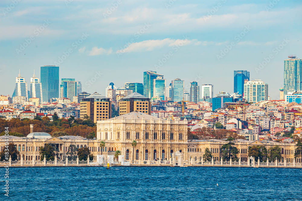Fototapeta premium View from a ferry of Dolmabahçe Palace and the business district. Modern contrasts.