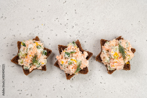Sourdough bread topped with salmon pate served on a light background