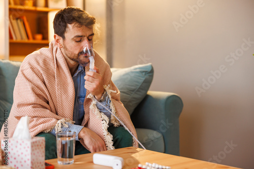 Man having flu and fever using inhaler