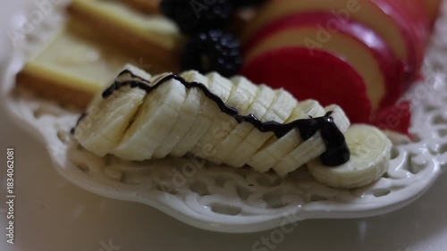 chocolate syrup dripping onto sliced fruit