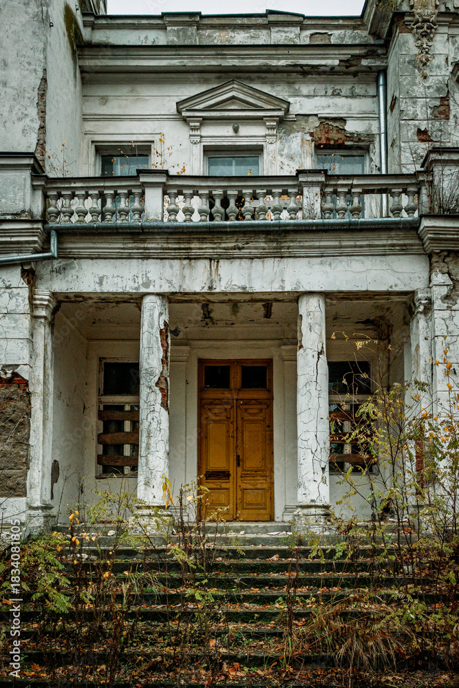 Fototapeta premium Old Abandoned Building with Cracked Facade and Yellow Doors
