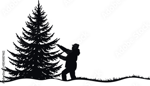 Silhouette of man decorating Christmas tree in snowy landscape  