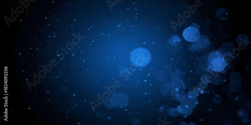 Abstract dark blue background with glowing particles in motion, suggesting a starry night sky or bright winter holiday space