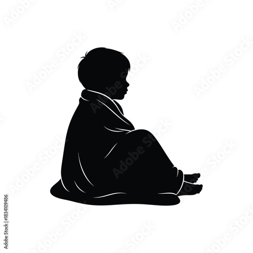 A young child sitting in a blanket silhouette