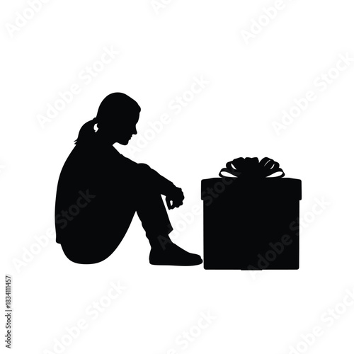 Sad silhouette of a person sitting next to a gift silhouette