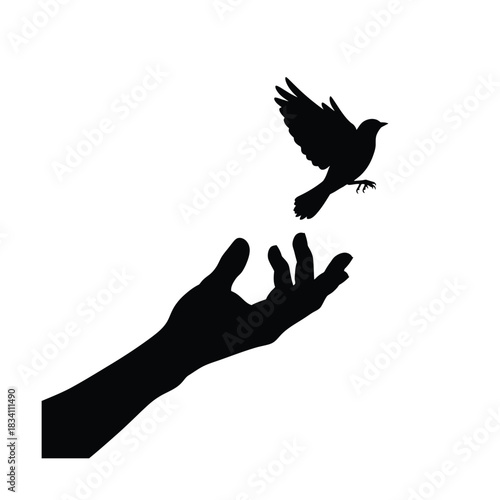 Silhouette of a hand releasing a bird into the sky silhouette