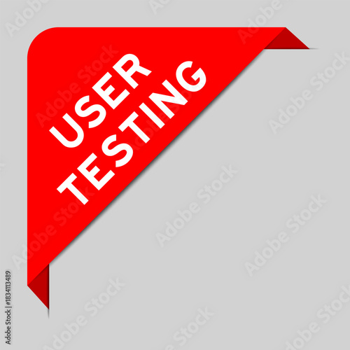 Red color of corner label banner with word user testing on gray background