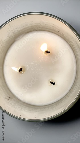 A man blows out a triple holiday candle