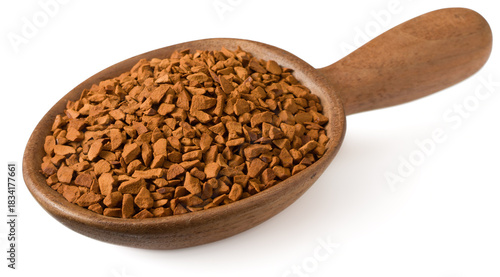 Freeze dried coffee powder in a wooden spoon, isolated on a white background.