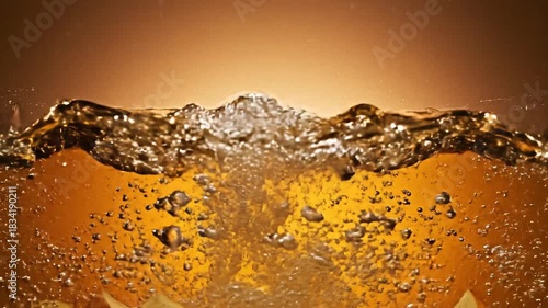 Closeup of turbulent amber liquid with numerous bubbles